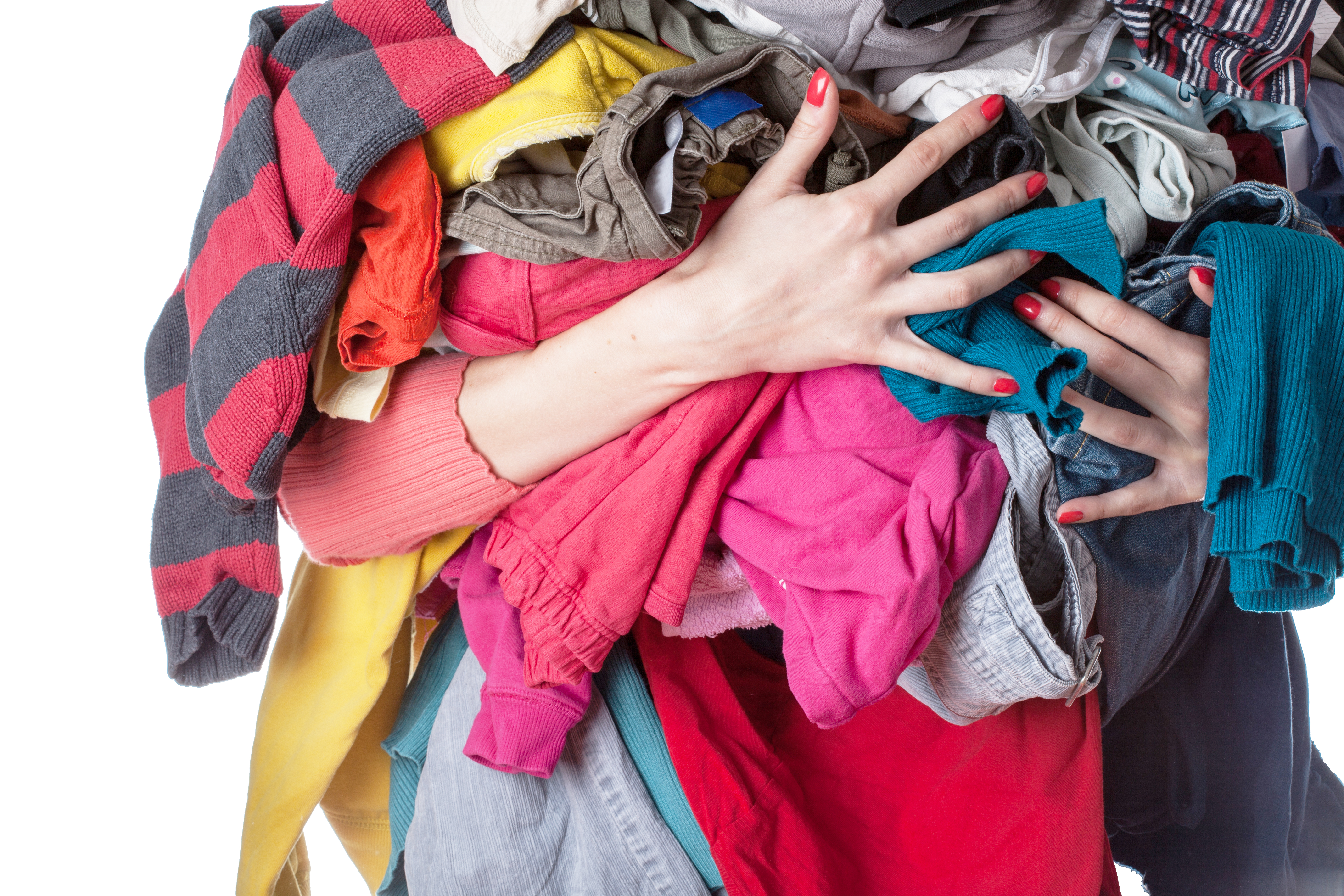 Woman holding a huge pile of clothes